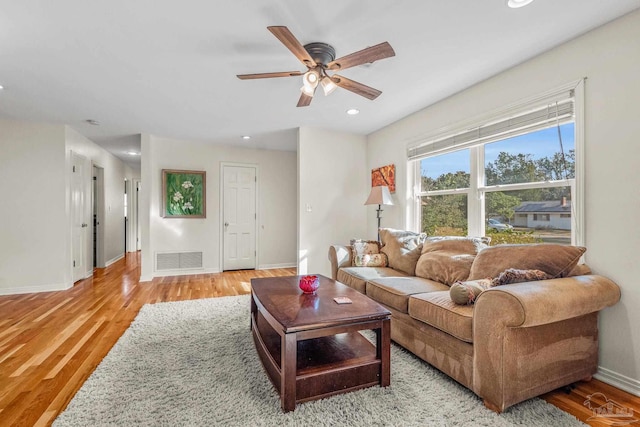 living room featuring ceiling fan and light wood-type flooring