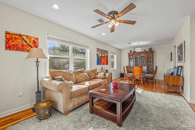 living room with hardwood / wood-style floors and ceiling fan