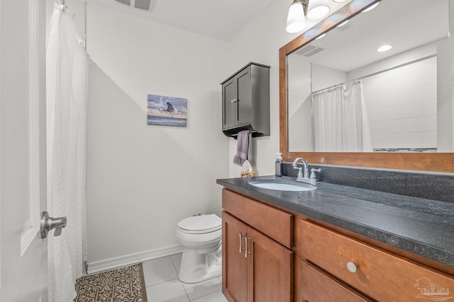 bathroom featuring tile patterned floors, toilet, and vanity