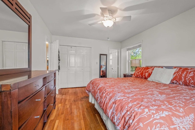 bedroom with ceiling fan, light wood-type flooring, and a closet