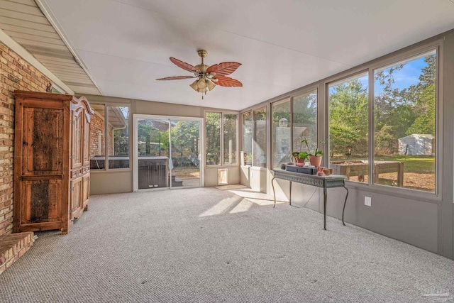 unfurnished sunroom featuring ceiling fan