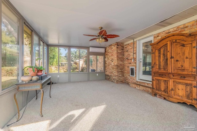 sunroom / solarium featuring ceiling fan and a wall unit AC