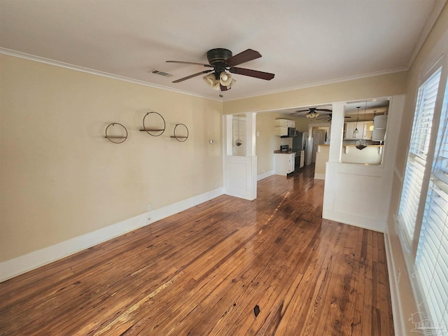 unfurnished room with ceiling fan, dark wood-style flooring, visible vents, baseboards, and ornamental molding