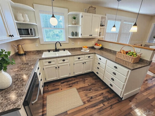 kitchen with open shelves, a peninsula, a sink, and dark wood finished floors