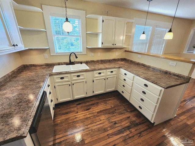 kitchen featuring a peninsula, dark wood-style floors, open shelves, and a sink