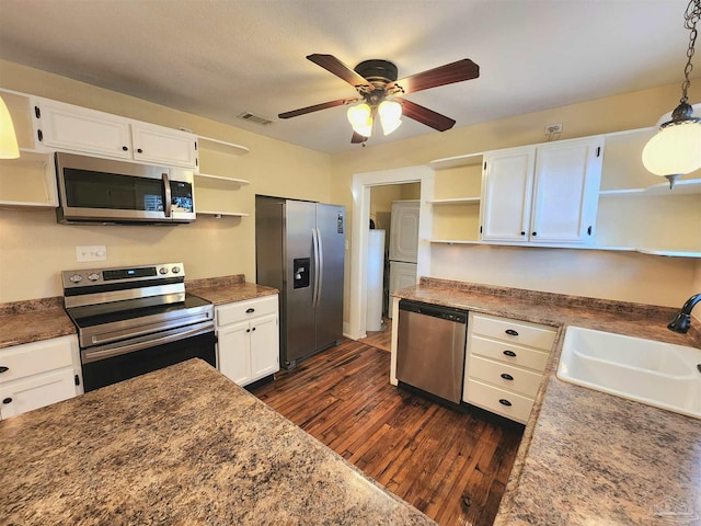 kitchen featuring stainless steel appliances, visible vents, a sink, and open shelves