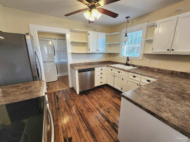 kitchen featuring open shelves, dark countertops, a sink, and stainless steel appliances