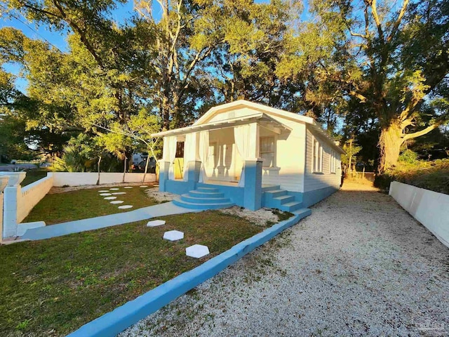 view of front of house featuring a front yard and fence