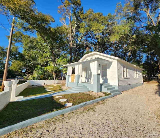 view of front of home with a front yard and fence