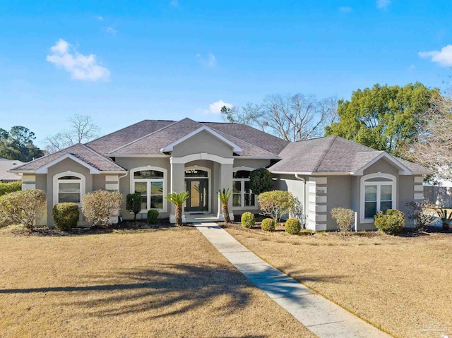 ranch-style home featuring a front yard