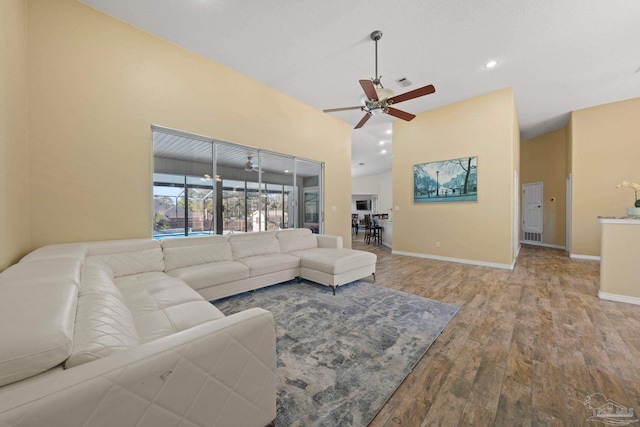 living room with light hardwood / wood-style floors and ceiling fan