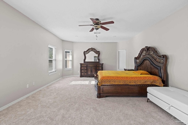 bedroom with ceiling fan and light carpet