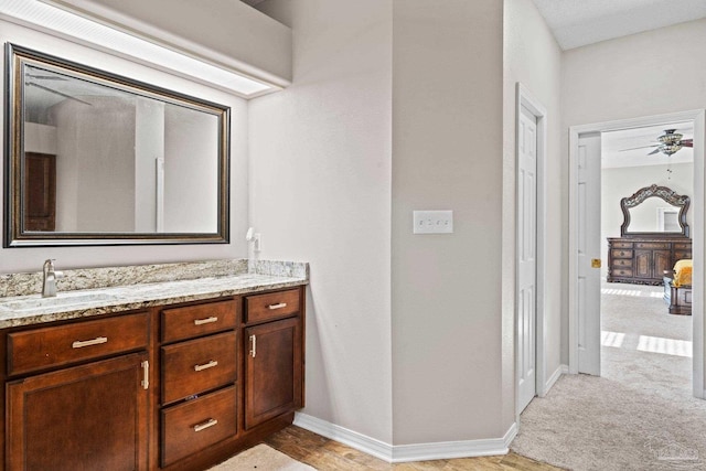 bathroom featuring ceiling fan and vanity