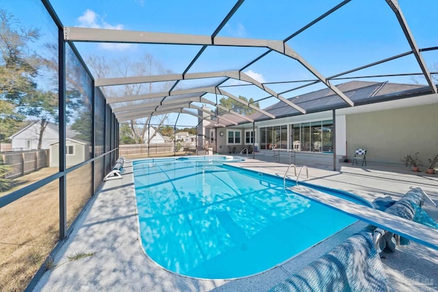 view of swimming pool featuring a lanai and a patio area