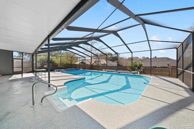 view of swimming pool with a patio and a lanai