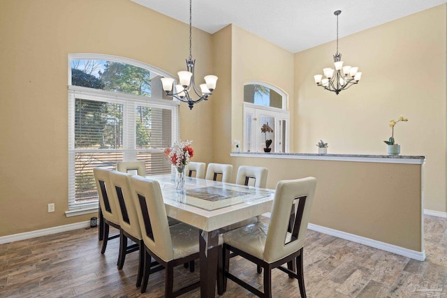 dining area featuring an inviting chandelier and wood-type flooring