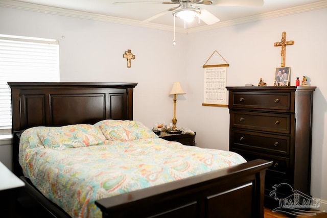 bedroom with ornamental molding and ceiling fan