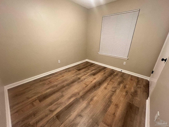 empty room featuring dark hardwood / wood-style flooring