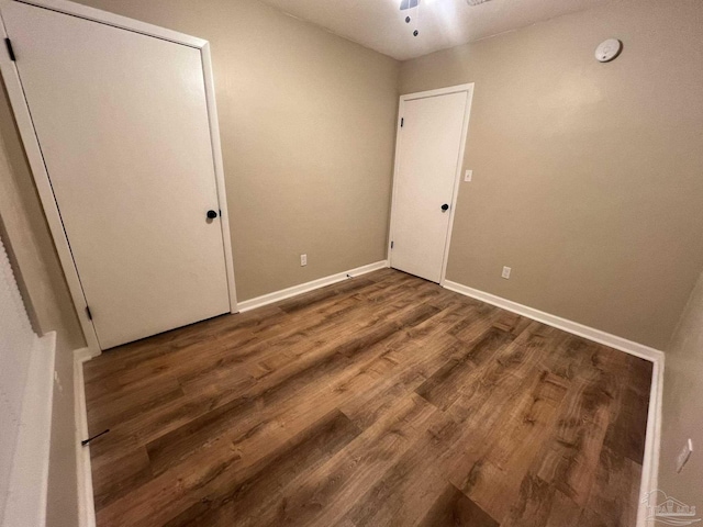 unfurnished room featuring dark wood-type flooring