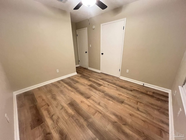 empty room with ceiling fan and wood-type flooring