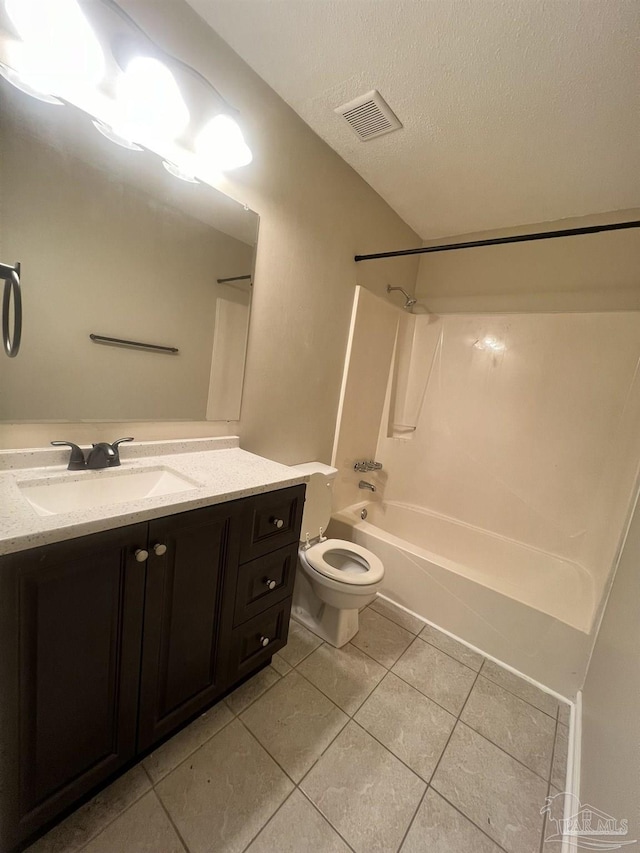 full bathroom featuring shower / washtub combination, vanity, toilet, tile patterned floors, and a textured ceiling