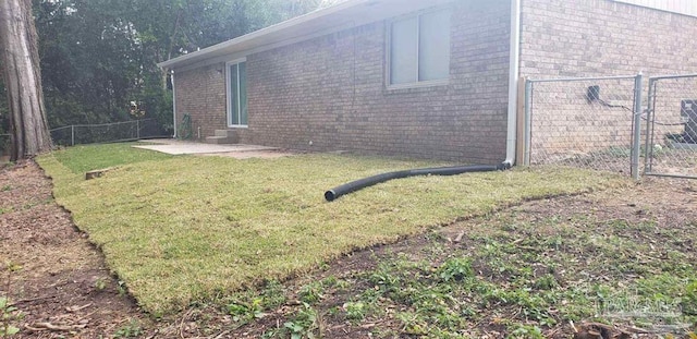 view of property exterior with a lawn and a patio