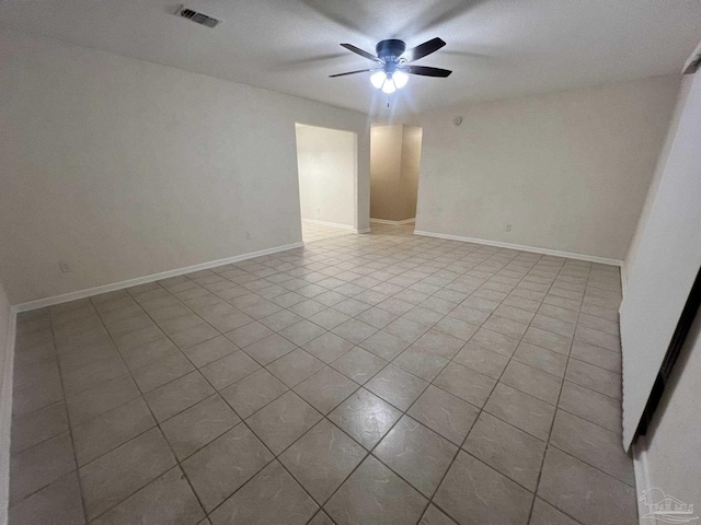 empty room with light tile patterned floors and ceiling fan