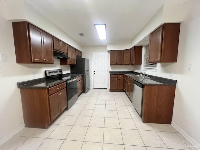 kitchen with light tile patterned flooring, dark brown cabinetry, appliances with stainless steel finishes, and sink