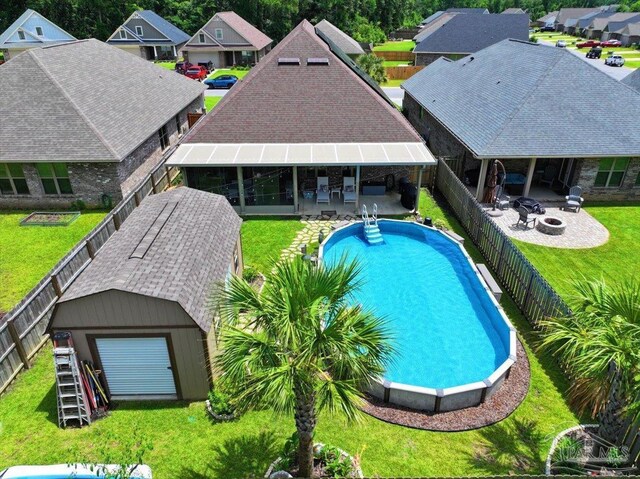 3920 Shady Grove Dr, Pace, FL 32571 - swimming pool featuring an outdoor fire pit, an outdoor structure, a patio, and a residential view