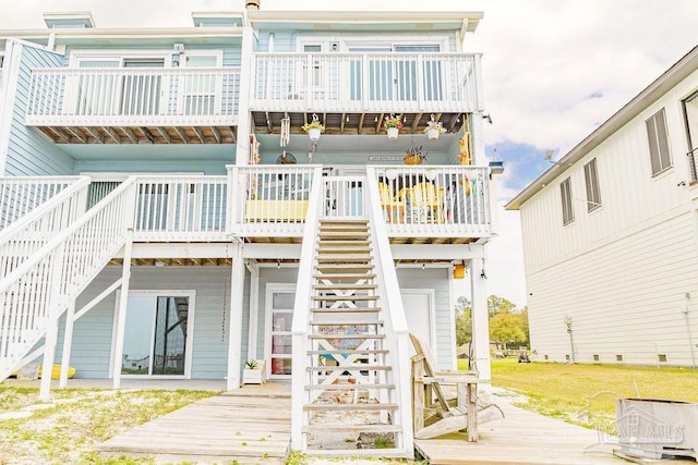 10443 Gulf Beach Hwy Unit 1, Pensacola, FL 32507 - back of property featuring a lawn, a wooden deck, and stairway