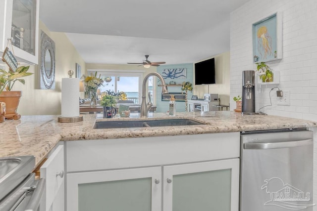 10443 Gulf Beach Hwy Unit 1, Pensacola, FL 32507 - kitchen featuring a ceiling fan, stainless steel appliances, a sink, light stone counters, and white cabinets