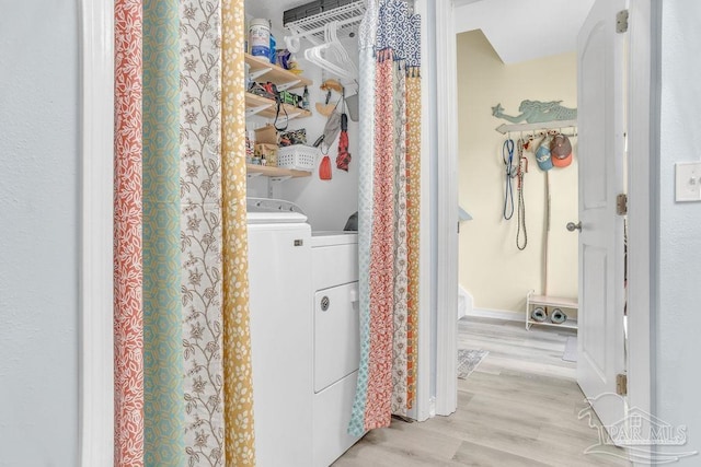 10443 Gulf Beach Hwy Unit 1, Pensacola, FL 32507 - clothes washing area with independent washer and dryer, light wood-style flooring, and laundry area
