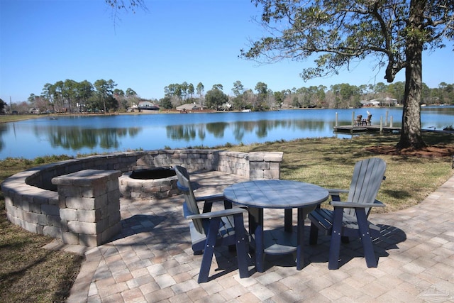 view of patio / terrace with an outdoor fire pit and a water view