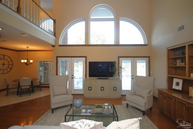 living area with french doors, wood finished floors, and visible vents