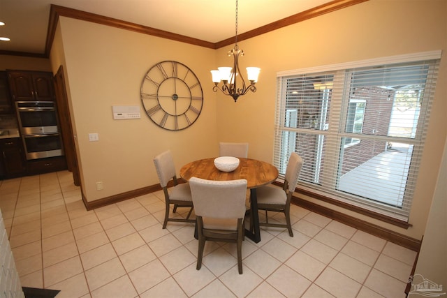 dining room with light tile patterned floors, baseboards, a notable chandelier, and crown molding