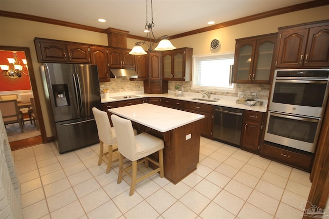 kitchen with appliances with stainless steel finishes, a sink, under cabinet range hood, and light tile patterned floors