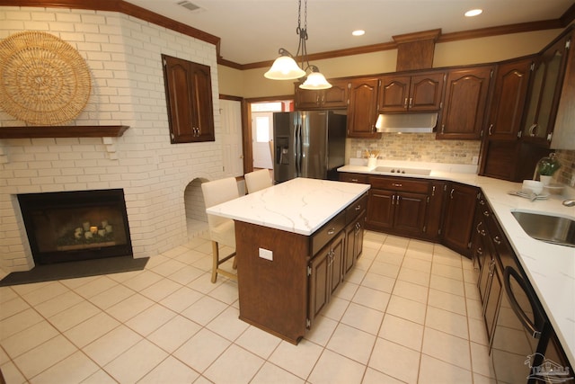 kitchen featuring light tile patterned floors, black electric stovetop, a breakfast bar area, under cabinet range hood, and stainless steel refrigerator with ice dispenser