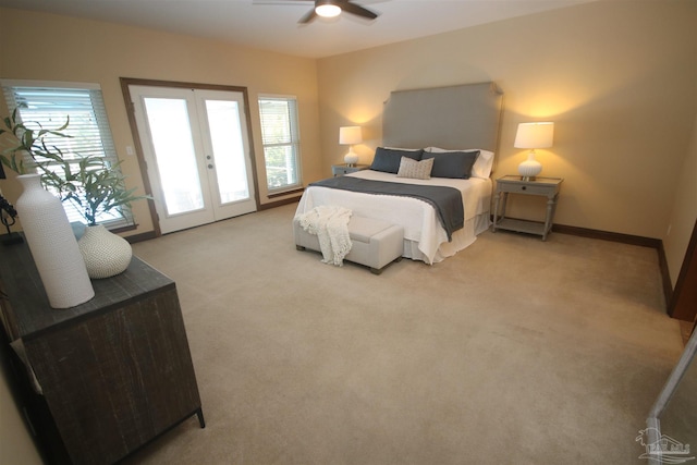 carpeted bedroom featuring baseboards, french doors, multiple windows, and access to exterior