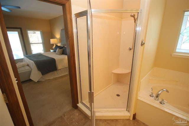 ensuite bathroom featuring a garden tub, a stall shower, connected bathroom, and a wealth of natural light