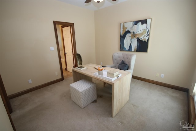 home office with light carpet, ceiling fan, and baseboards