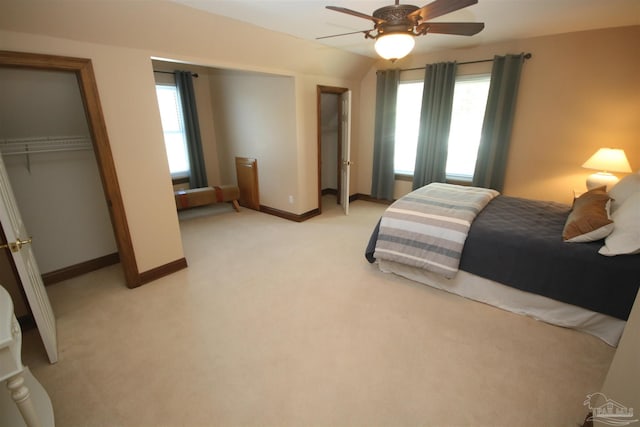 bedroom with light carpet, ceiling fan, multiple windows, and baseboards