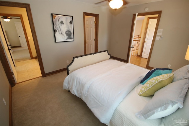 bedroom featuring ceiling fan, baseboards, and light colored carpet