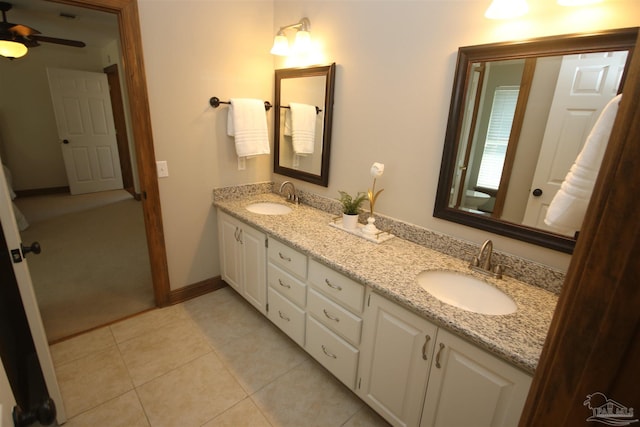 full bathroom featuring ceiling fan, double vanity, tile patterned flooring, and a sink