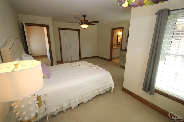 carpeted bedroom featuring multiple windows, baseboards, and a closet