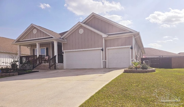 view of front of property with a porch, concrete driveway, an attached garage, fence, and a front lawn