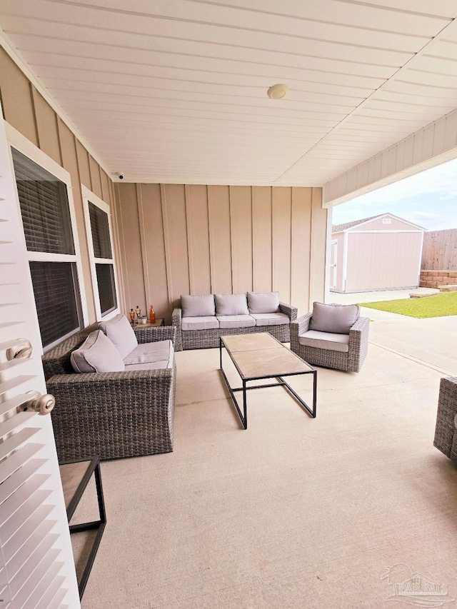 view of patio / terrace with a storage shed, an outdoor living space, and an outdoor structure