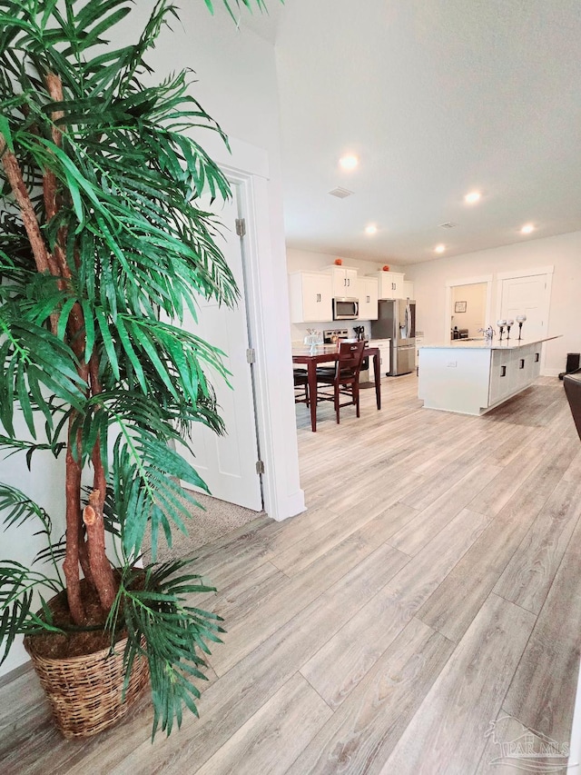 interior space featuring recessed lighting, visible vents, and light wood-style floors