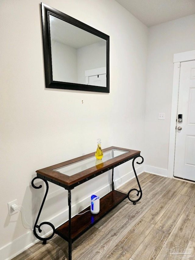 entryway featuring baseboards and wood finished floors