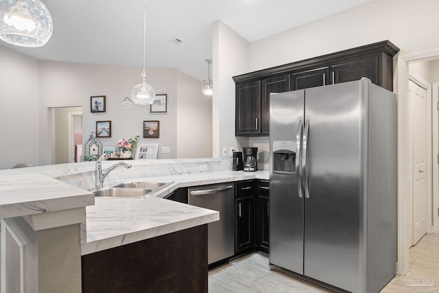 kitchen with pendant lighting, sink, stainless steel appliances, and kitchen peninsula