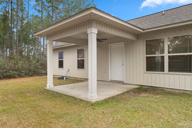 property entrance featuring a patio, ceiling fan, and a lawn